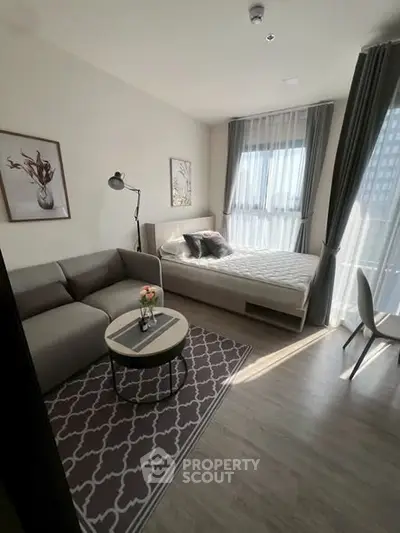Modern studio apartment with cozy living area and natural light