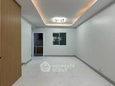 Spacious modern living room with elegant ceiling lighting and sleek flooring