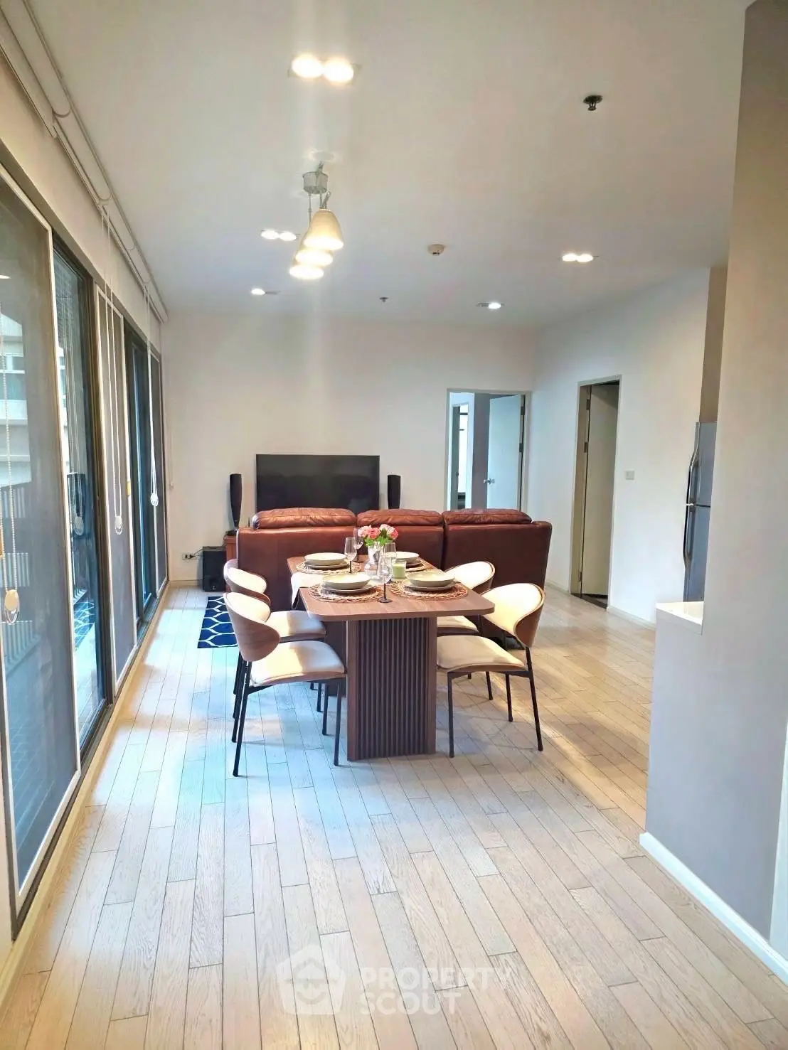 Spacious modern living room with dining area and large windows