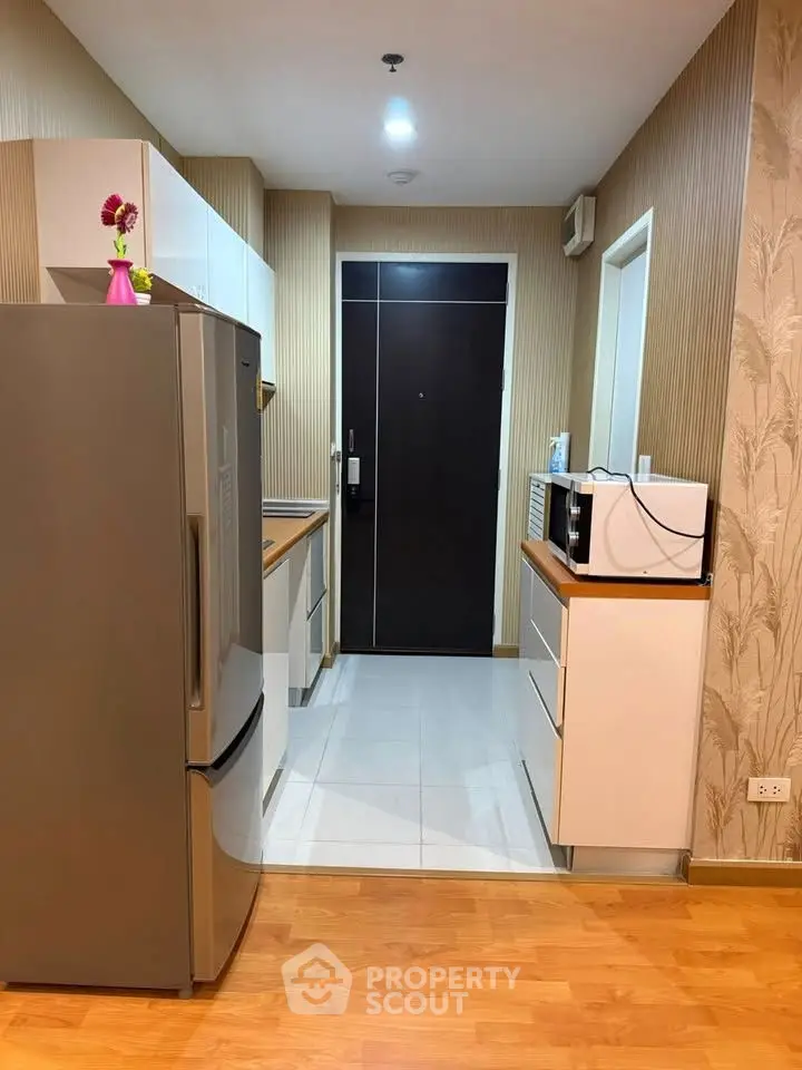 Modern kitchen with sleek appliances and stylish decor in a contemporary apartment.