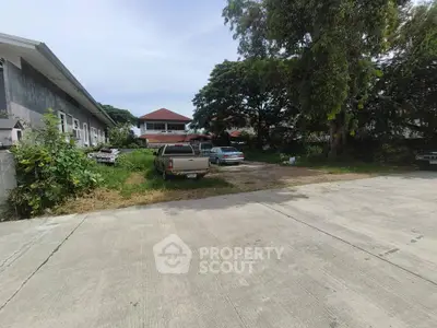 Spacious residential property with ample parking and lush greenery