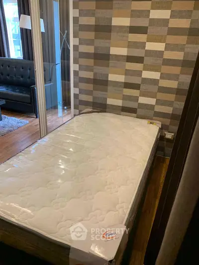 Modern bedroom with stylish decor and comfortable mattress in a cozy apartment.
