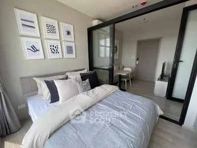 Modern bedroom with stylish decor and sliding glass doors leading to a cozy living area.