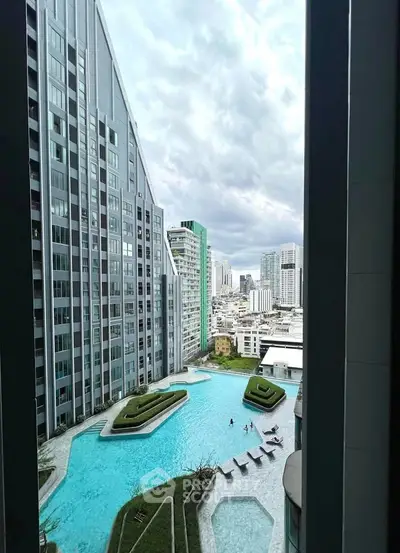Stunning cityscape view from a modern high-rise building with a luxurious pool and landscaped garden.
