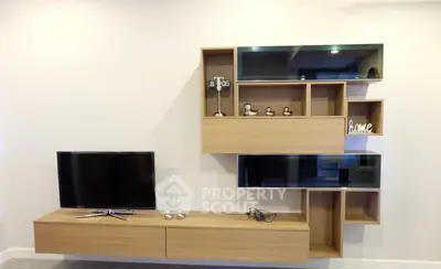 Modern living room with stylish wall-mounted TV and shelving unit