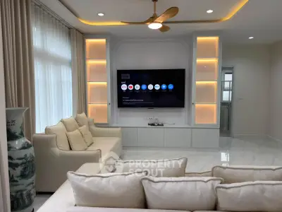 Luxurious modern living room with elegant lighting and large TV setup