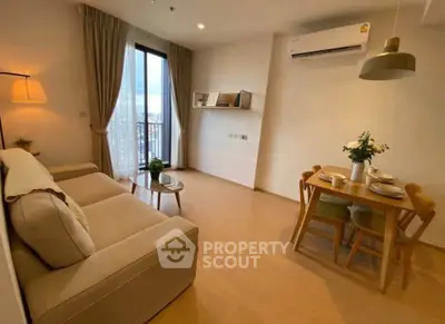 Cozy living room with modern decor and dining area, featuring a large window with city view.
