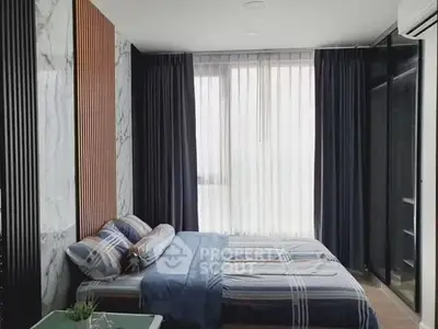 Modern bedroom with stylish decor and large window for natural light