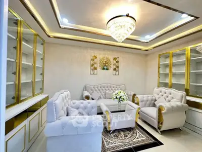 Luxurious living room with elegant chandelier and plush seating in a modern home.