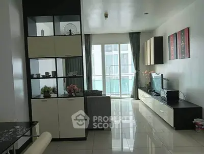 Modern living room with sleek furniture and large windows offering natural light.