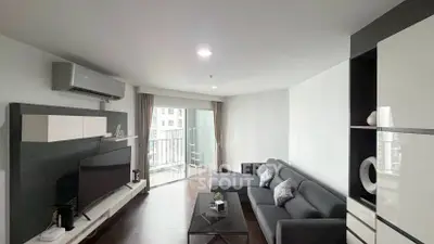 Modern living room with sleek furniture and balcony access in a stylish apartment.