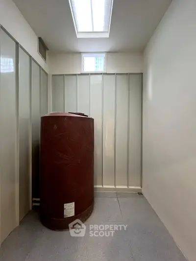 Spacious storage room with large water tank and ample light