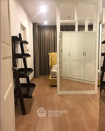 Stylish bedroom with mirrored wardrobe and elegant shelving unit
