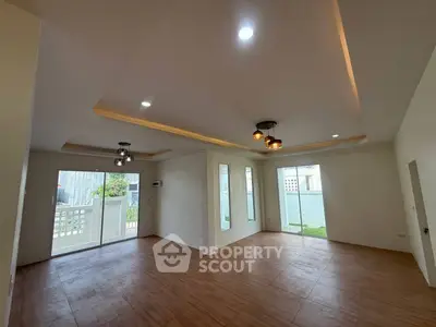 Spacious modern living room with elegant lighting and large windows