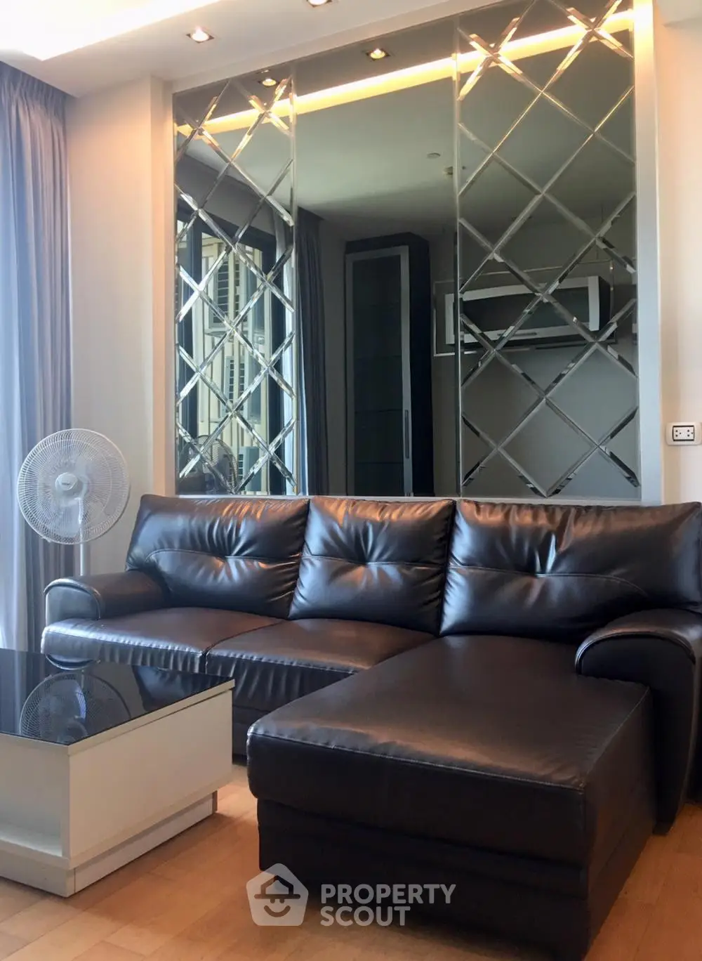 Luxurious living room with elegant leather sofa and mirrored wall design