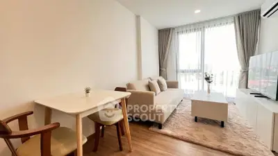 Modern living room with cozy sofa, stylish table, and large window view.