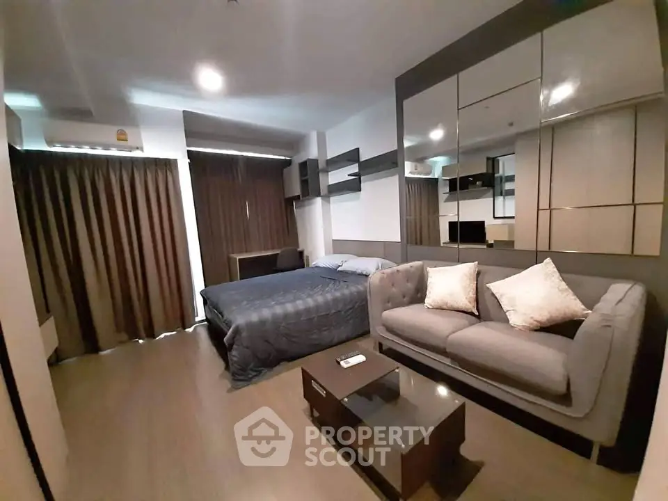 Modern studio apartment with cozy living area and stylish decor