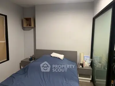 Cozy bedroom with modern furnishings and ample natural light, perfect for relaxation and comfort.