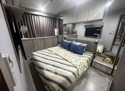 Cozy modern bedroom with stylish decor and ample storage space.