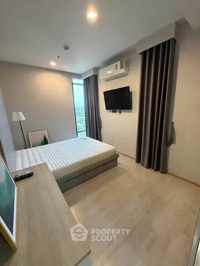 Modern bedroom with minimalist decor, featuring a large window and wall-mounted TV.