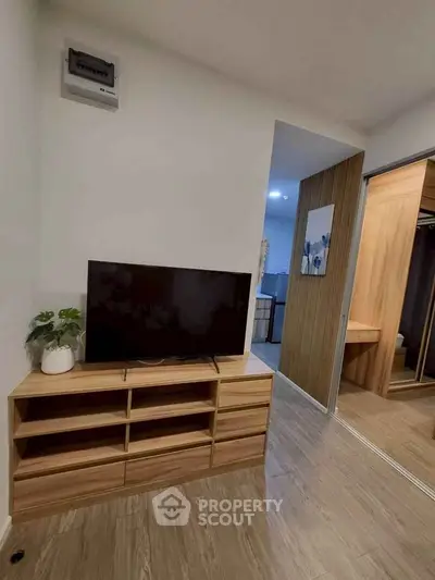 Modern living room with sleek wooden TV stand and stylish decor