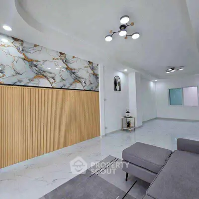 Modern living room with elegant marble accents and stylish lighting