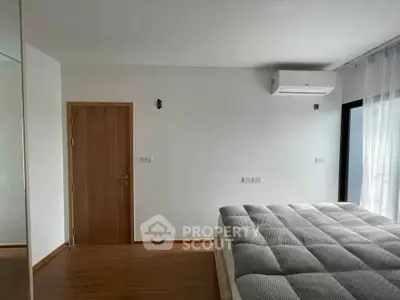 Spacious bedroom with modern air conditioning and natural light