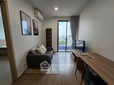 Modern living room with balcony view, cozy sofa, and sleek decor in urban apartment.