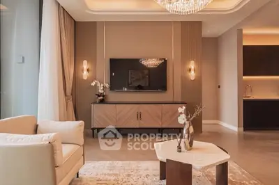 Luxurious living room with elegant decor and modern furnishings, featuring a stylish chandelier and sleek TV setup.