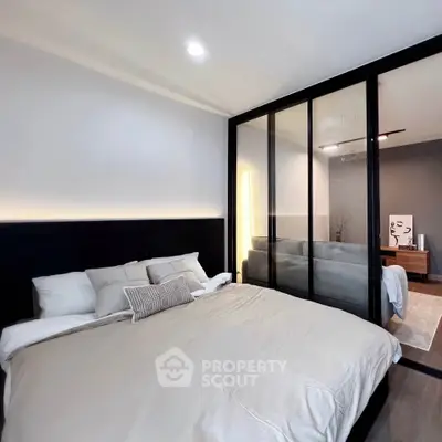 Modern bedroom with glass partition and cozy decor