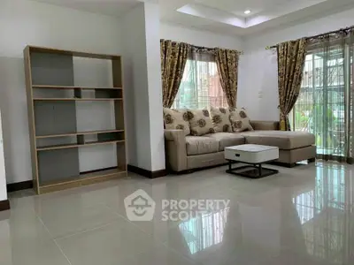 Spacious living room with modern sofa and elegant curtains, perfect for family gatherings.