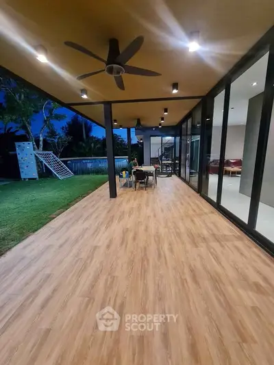 Stunning modern patio with wood flooring and ceiling fan, perfect for outdoor relaxation.