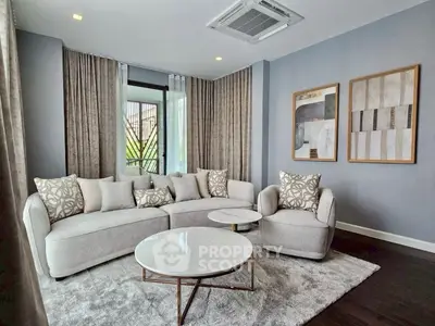 Elegant living room with modern furniture and stylish decor, featuring a cozy sofa and chic coffee table.