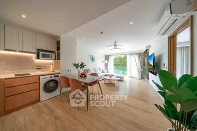 Spacious open-plan living room with modern kitchen and garden view