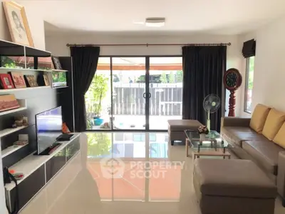 Spacious living room with modern decor, large windows, and sleek furniture, perfect for relaxation and entertainment.