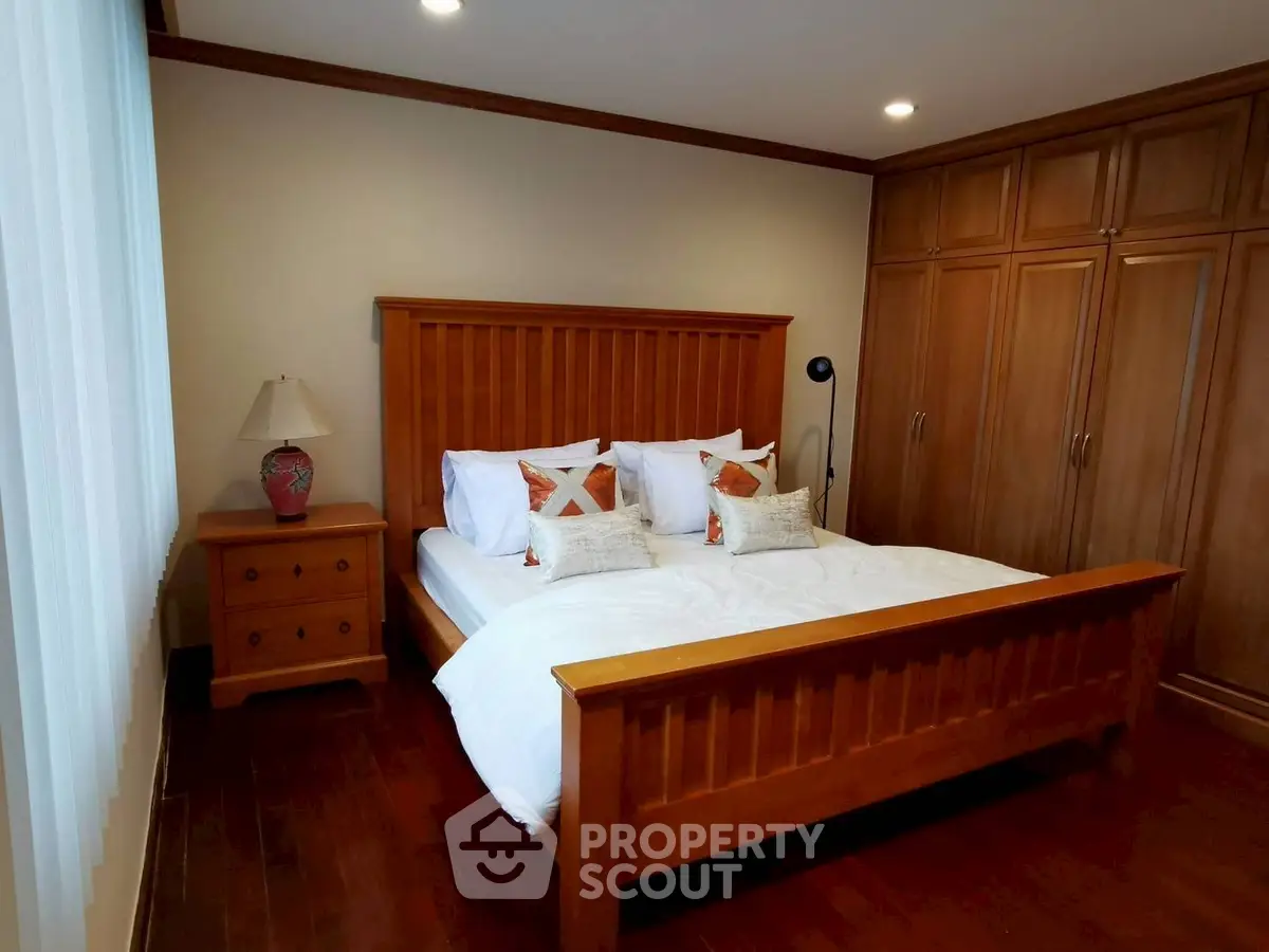Cozy bedroom with wooden furniture and ample closet space