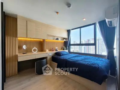 Modern bedroom with city view, featuring built-in desk and cozy bed setup.