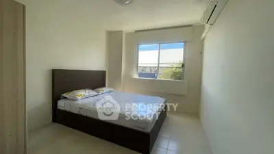 Bright minimalist bedroom with large window and air conditioning unit.