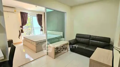 Modern studio apartment with glass partition, cozy living area, and natural light.