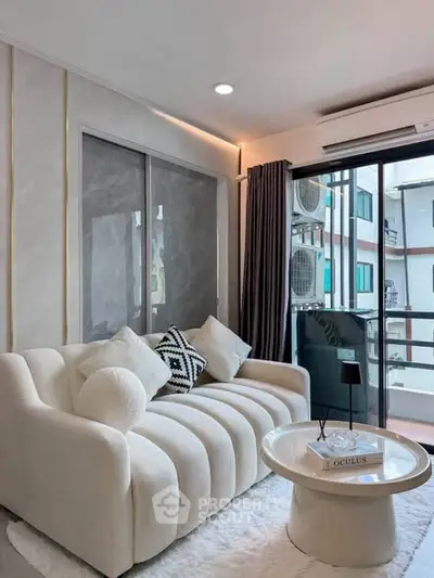 Modern living room with stylish sofa and balcony view in urban apartment