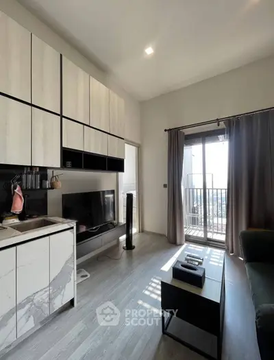 Modern living room with sleek cabinetry and balcony view