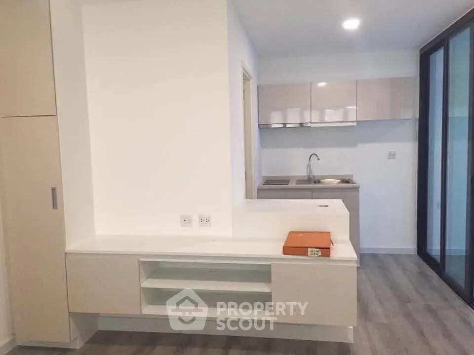 Modern kitchen with sleek cabinetry and open layout in contemporary apartment.