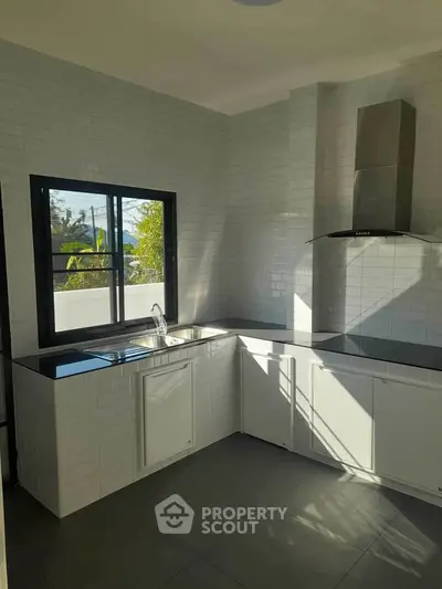 Modern kitchen with sleek design and ample natural light
