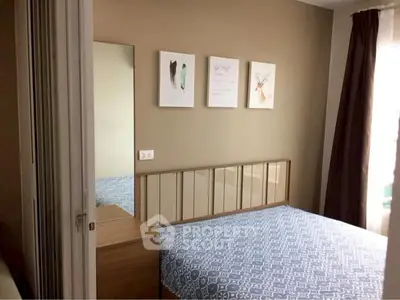 Cozy bedroom with modern decor and stylish artwork on the wall.