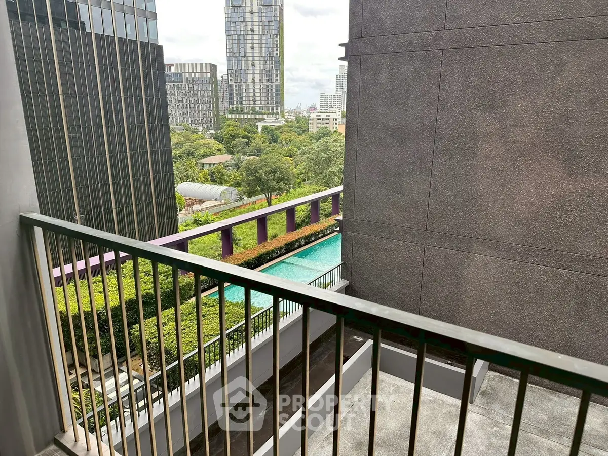 Modern city view from balcony overlooking pool and skyscrapers