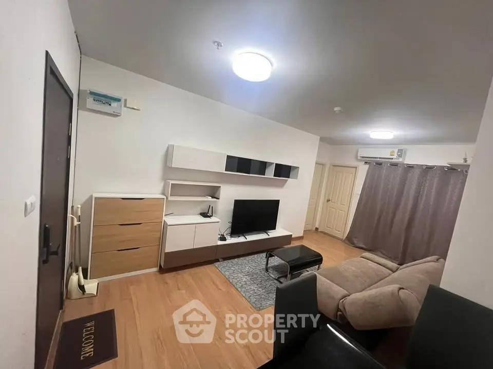 Modern living room with stylish furniture and wooden flooring in a cozy apartment.