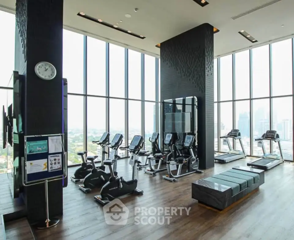 Luxurious high-rise gym with panoramic city views and modern fitness equipment.