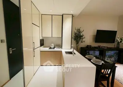 Modern kitchen with sleek cabinetry and dining area in stylish apartment