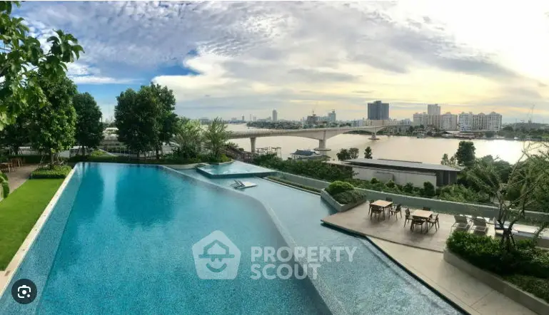 Stunning waterfront view with poolside seating and lush greenery