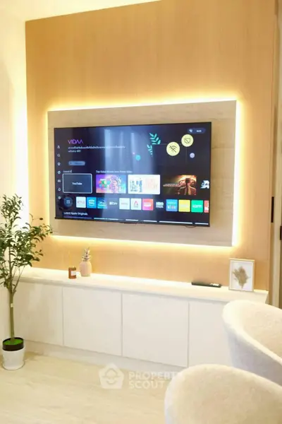 Modern living room with sleek TV setup and ambient lighting